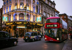 London, UK - November 23, 2015: Pedestrians, buses and taxis passing the Gielgud Theatre on Shaftesbury Avenue in London's West End, an area well known for theatre productions.